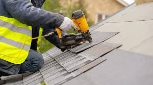 roofer installing roofing shingles 